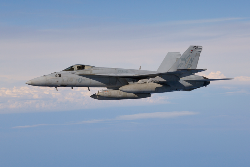 An F/A-18E from VFA-147 carrying three external fuel tanks for the carrier refueling mission.